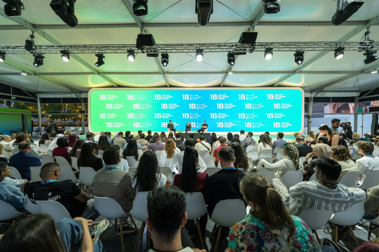 Audience watching a product presentation on a large screen